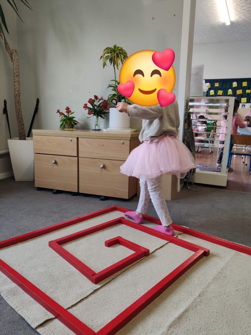 Child working with the Montessori Pink Tower to develop coordination and visual discrimination. - News  | Montessori Children's House